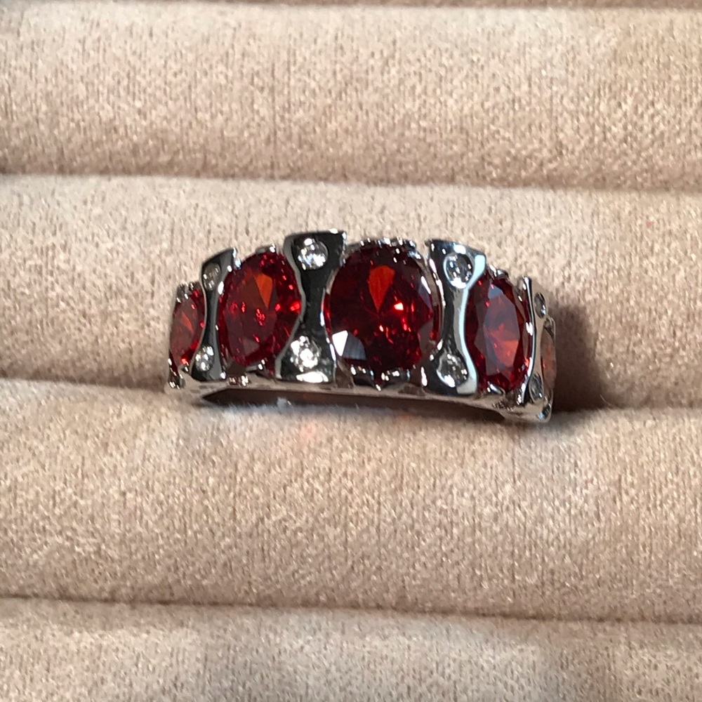 Large Rubies in a Row Across Silver Tone Metal